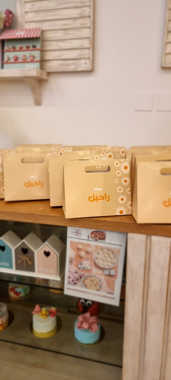 A set of (10) high-end paper bags in the shape of a suitcase